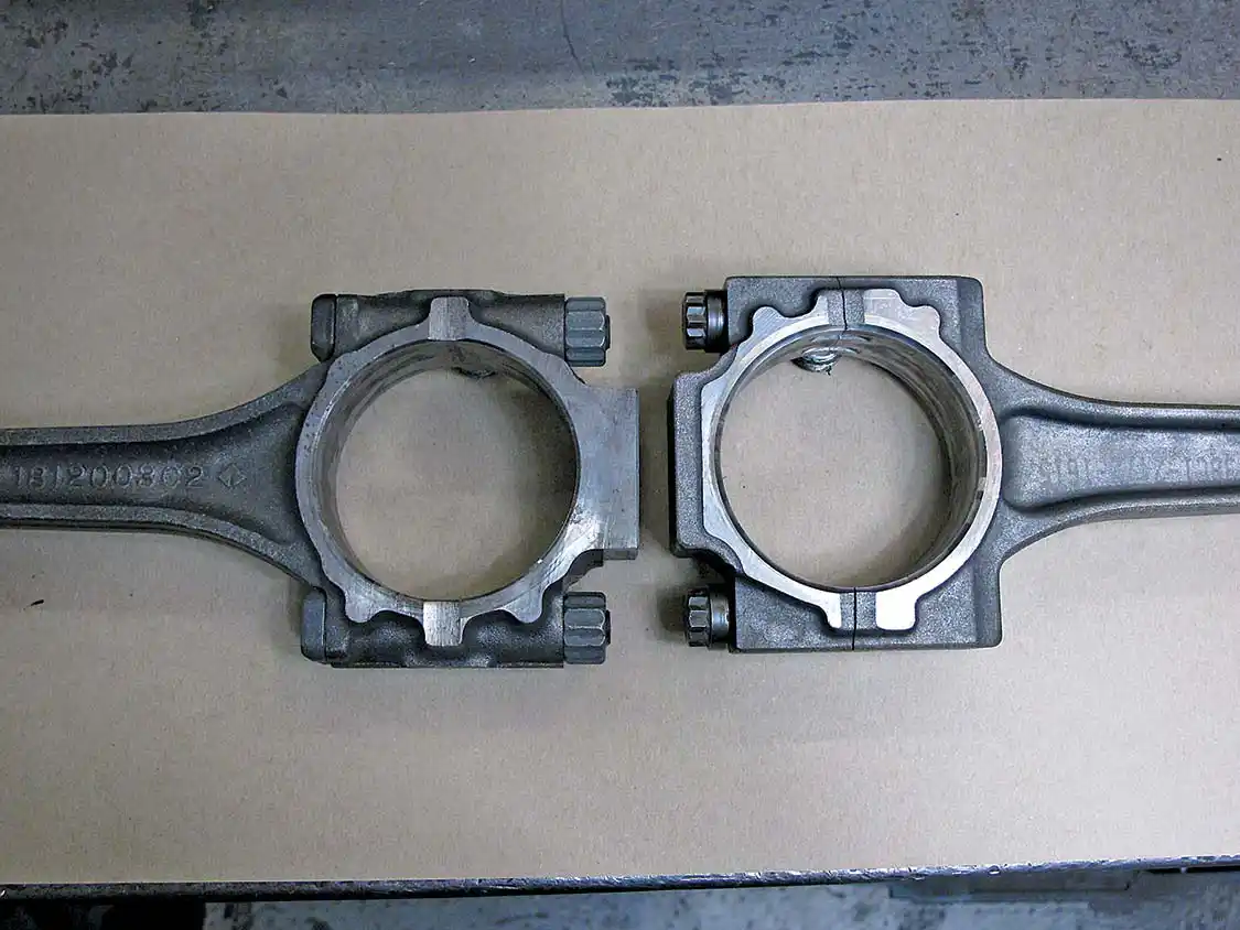 10. Here you see the two types of OEM piston rods used in the 7.3L Ford diesel engines. On the left is one of the later model forged rods with cap studs. On the right is a powdered metal rod that uses rod bolts. The forged rods are preferable. The bolt-style rods have been tagged as “crack rods” by Ford diesel enthusiasts, as they tend to crack on the bolt interface, when the stock bolts stretch. <a href="https://arp-bolts.com/">ARP</a> offers a rod bolt kit for this type of rod, which greatly lessens this problem. The forged rods are still preferred, but your motor might not come with them.
