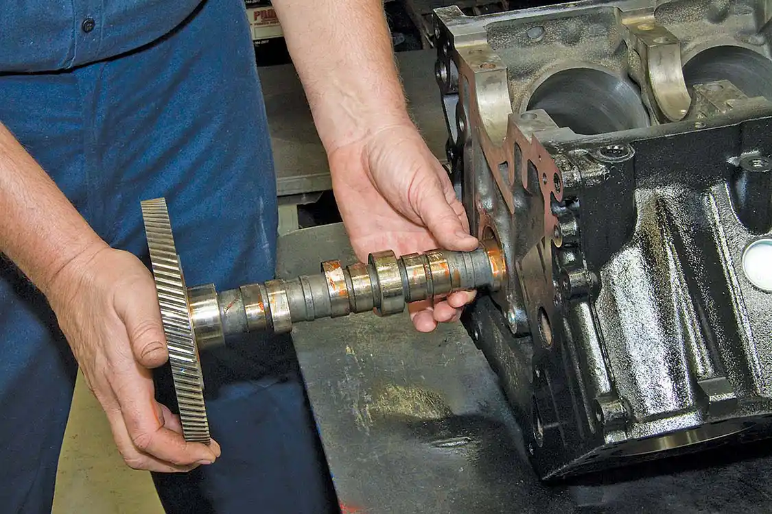 12. After the refurbishing, the block is ready for reassembly. Here you see the camshaft being installed. Since this engine is for a shop truck, a stock profile camshaft was used. For more performance, you can look to the aftermarket for many different grind profiles.