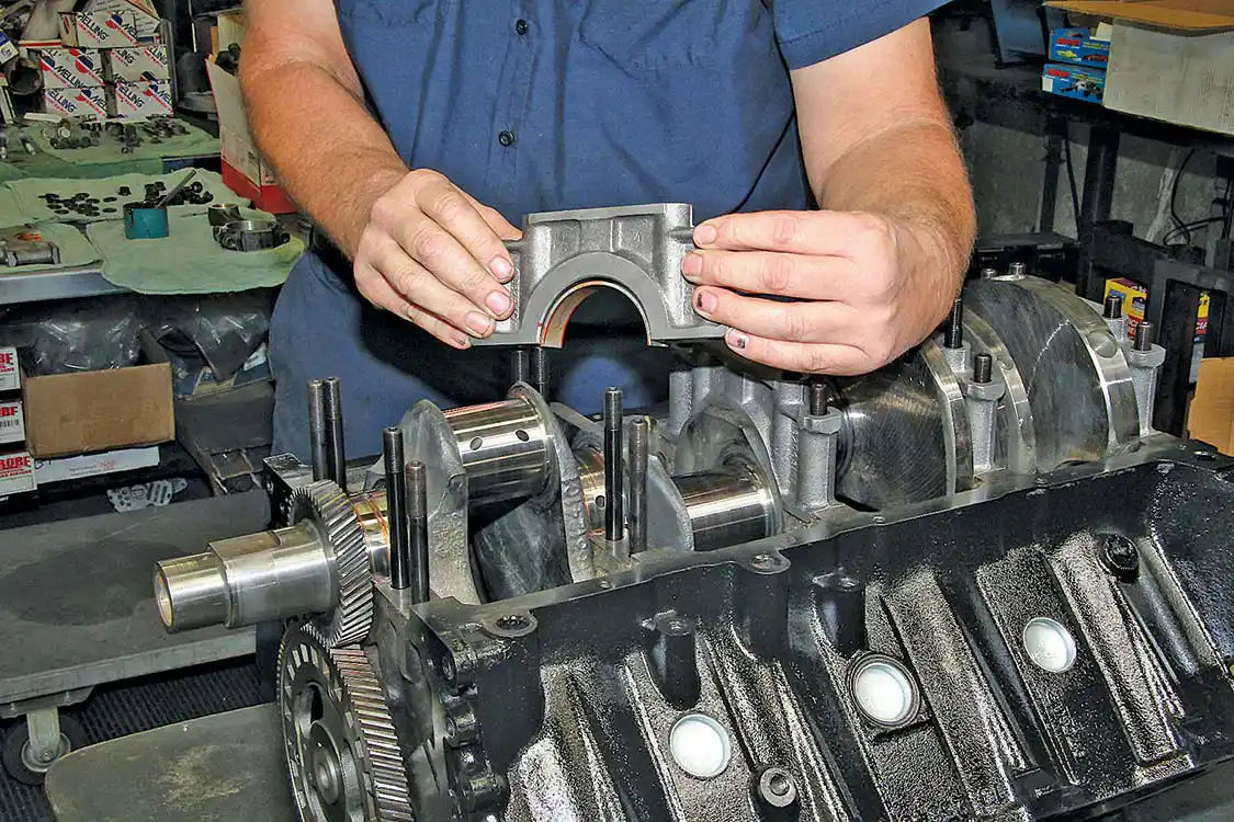17. A great upgrade for any engine is a set of main studs. Our 7.3L was upgraded with a set of studs from ARP. The studs are installed in the block, and then the main caps are dropped over them.