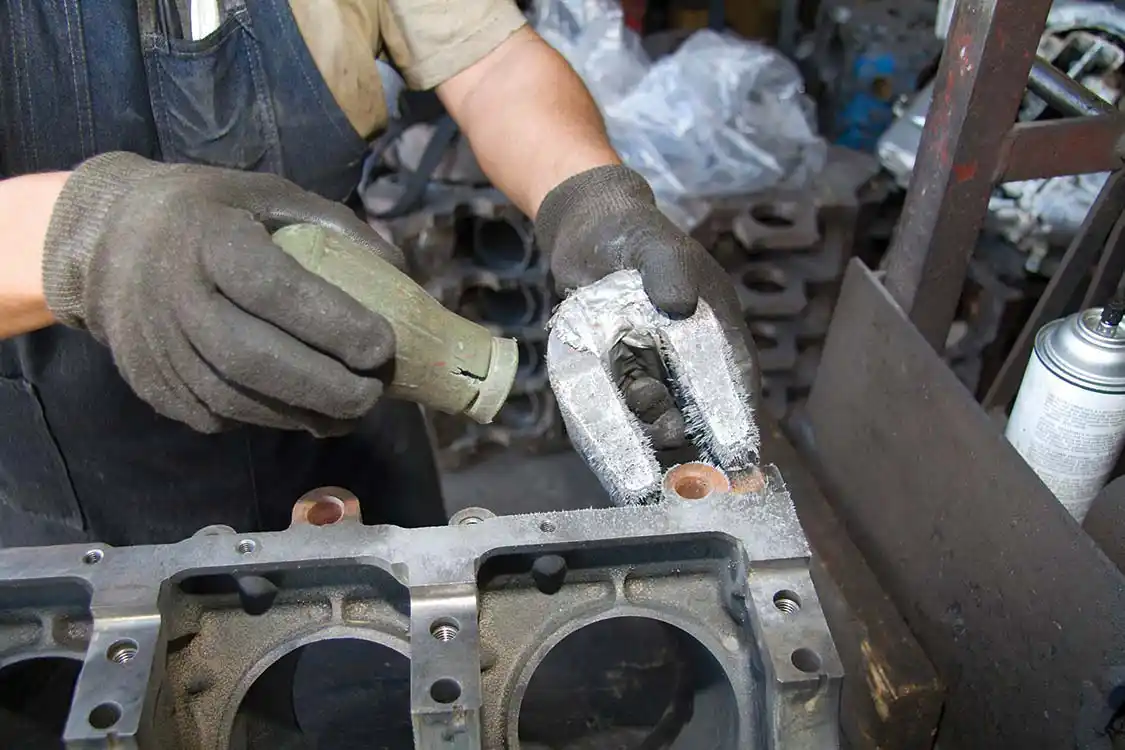 2. Once clean it’s thoroughly checked for any cracks. L&amp;R uses a very strong magnet and some iron powder for this, as cracks will show as an irregular pattern in the powder. Thankfully our engine block was crack free.
