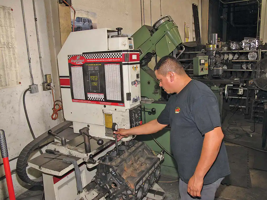 3. The block is put on a boring machine to ensure that all the piston holes (bores) are round, straight, and of the same size. We tried for a .020 over, but .030 was required to ensure full cleanup.