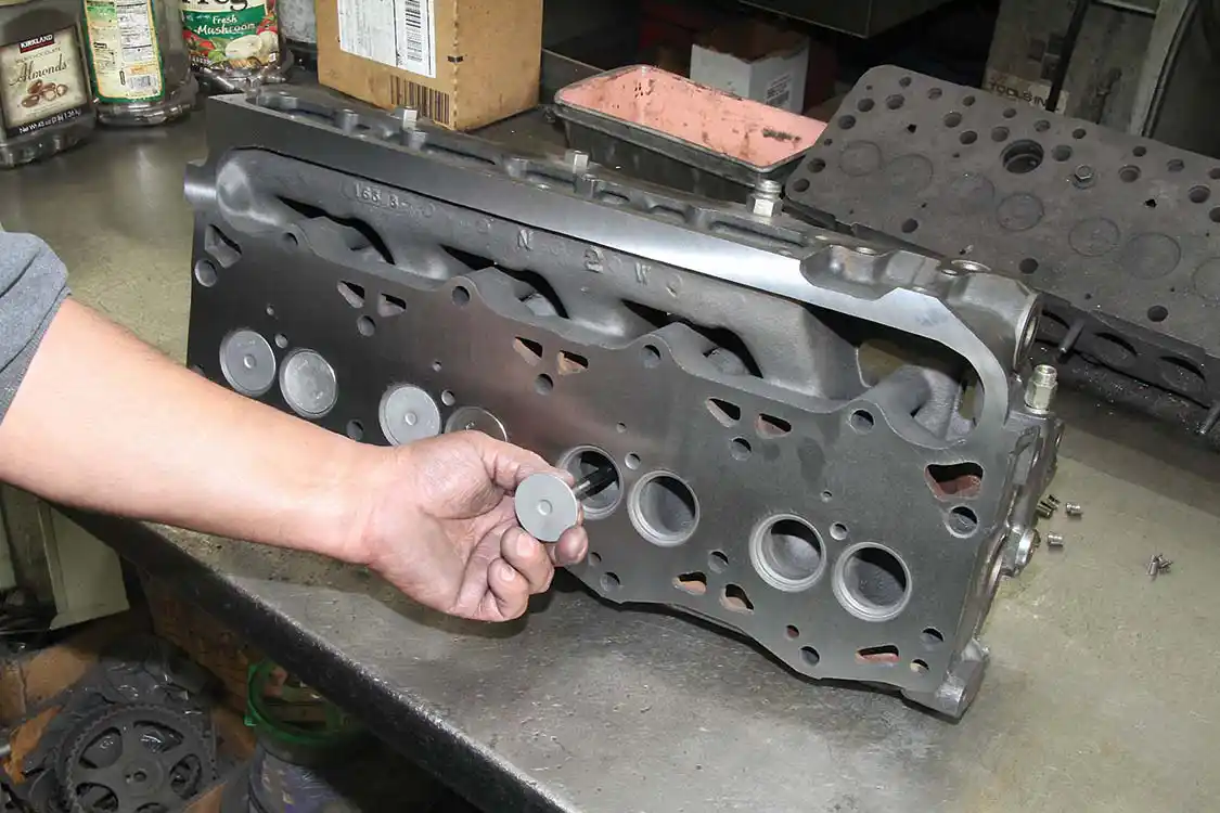 8. After a head is cleaned and surfaced, the valve seats are cleaned and resurfaced. The valve guides are also checked and renewed to spec if required. The final step is to install either new or reground valves in the valve pockets.