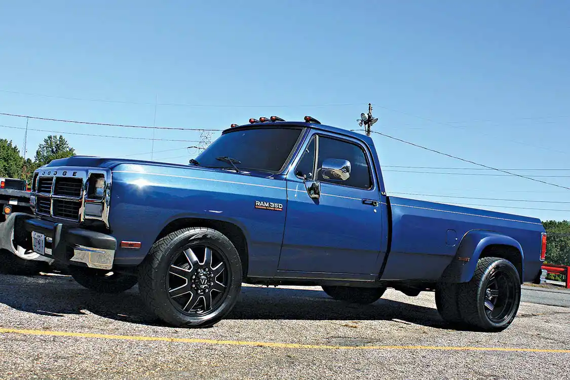 While the first generation Dodge Cummins trucks are nearly 25 years old, there are still a few making their way up and down the highway. Check out this pair of gen one Dodges we spotted out in the parking lot, a one of kind custom crew cab hauler and 3500 dually in better condition than it was coming off the Dodge assembly line.