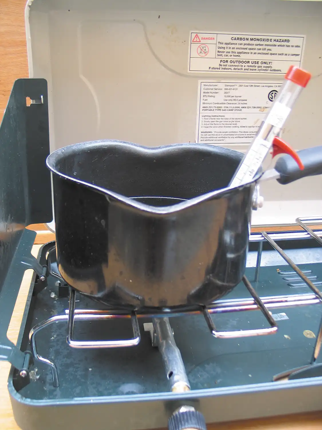 1. Place the one liter of vegetable oil in the pan and heat it on low until it reaches between 130 and 140 degrees Fahrenheit. Any higher than that and you will run the risk of melting your plastic mixing container.