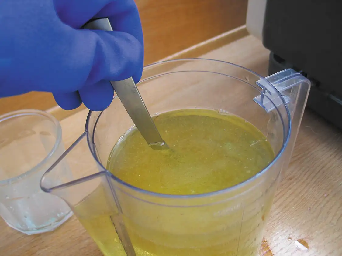 7. Secure the container’s lid and shake or stir it continuously for at least five minutes. If you are using a two-liter bottle, turn it upside down in a secure location and let it sit like this for at least two days. Over the course of those two days, you will notice that the glycerin and the biodiesel will begin to separate as visible layers in your bottle (that’s transesterification in action), with the glycerin, impurities, and debris settling to the bottom.