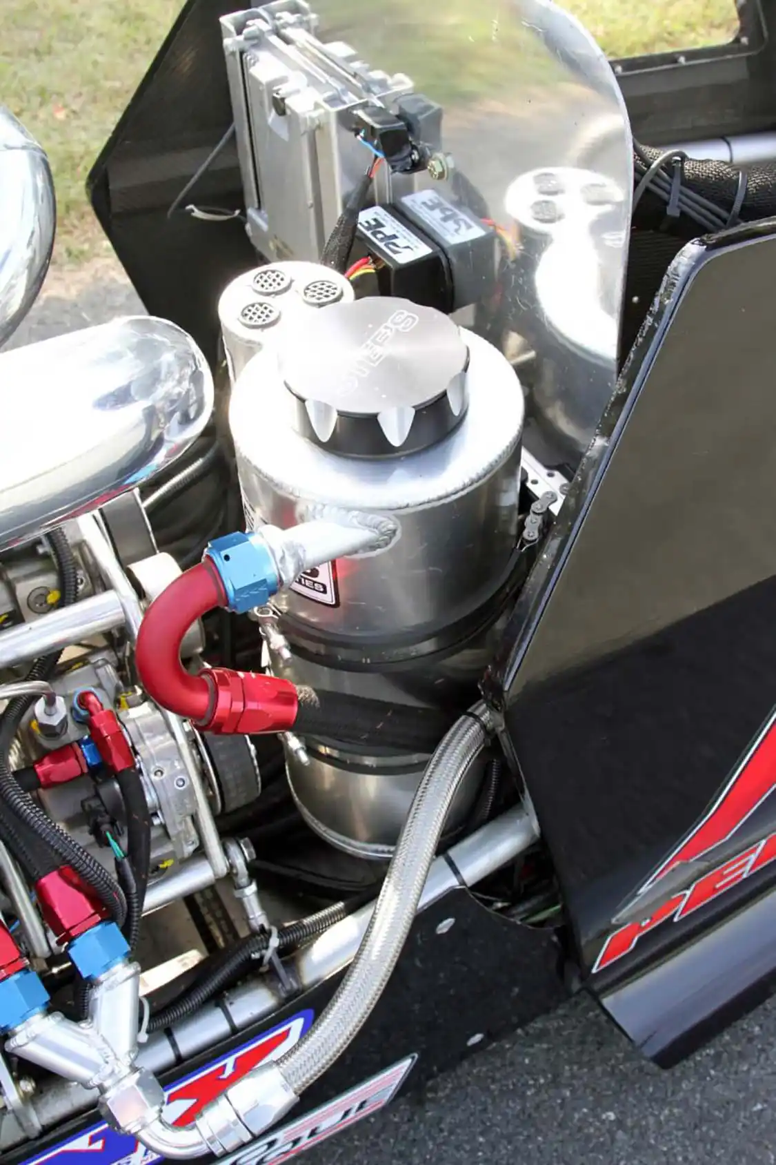 The firewall behind the driver seat holds the Stef’s oil tank for the dry sump system as well as the <a href="https://www.ppepower.com/shop/">PPE</a> Dual CP3 controller, OBD port and a factory <a href="https://www.gm.com/">GM</a> ECM.