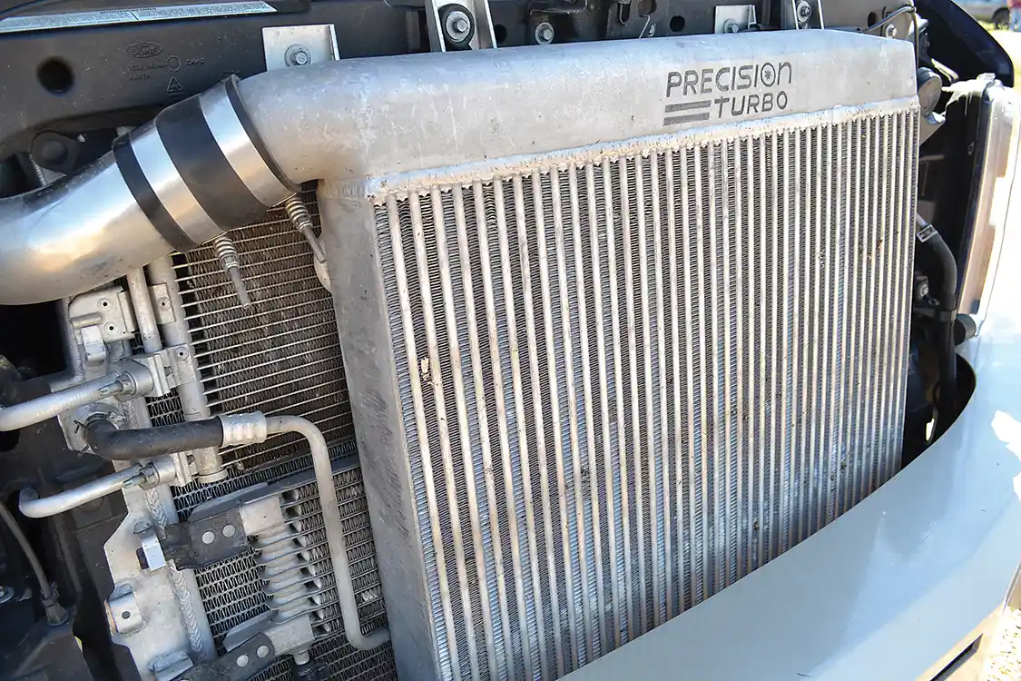 A higher-flowing <a href="https://www.precisionturbo.net/">Precision</a> intercooler handles cooling duties for the 90-psi of boost that’s created by the compound turbochargers. Highly efficient, the intercooler is a big part of keeping EGT in check. Erik reports that so far he only has seen about 1,400 to 1,500 degrees during full throttle blasts.