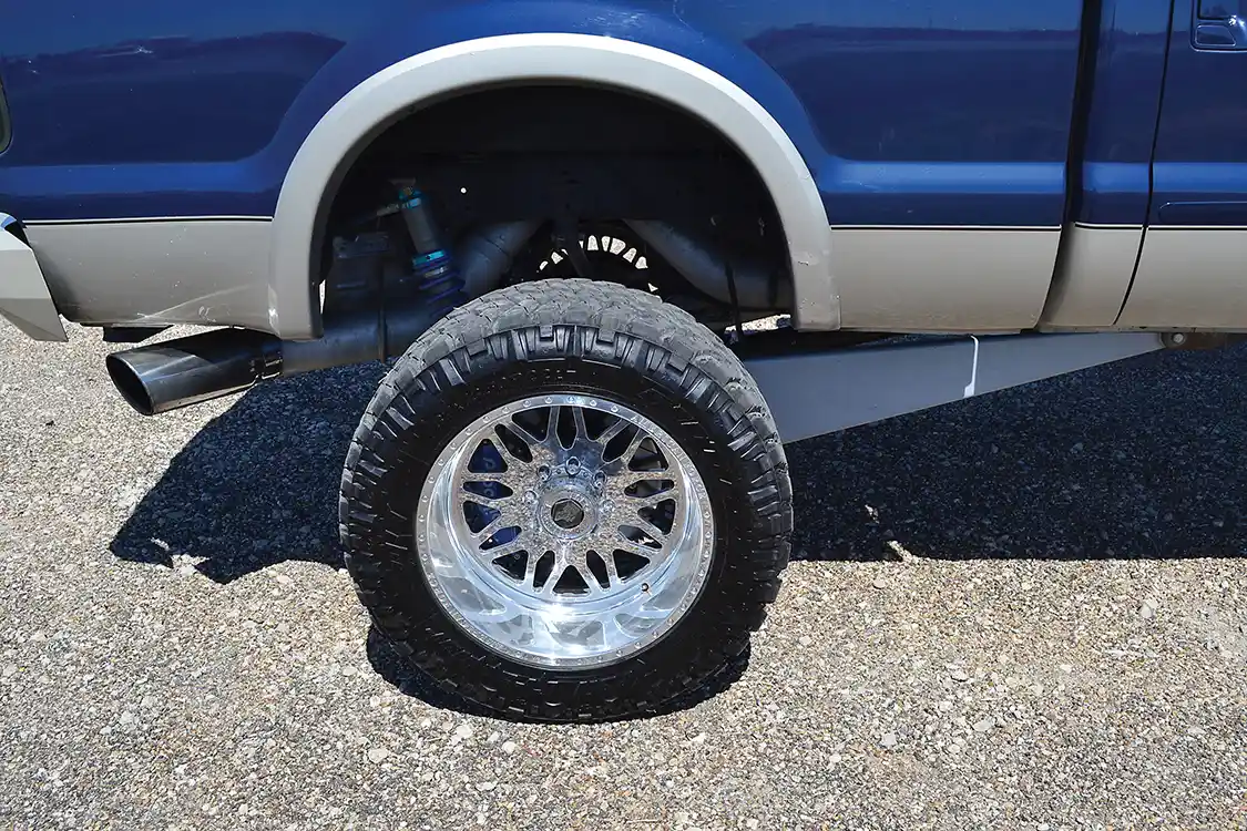While it might look like the truck has enormous traction bars, the links are actually part of the four-link suspension that provides 8 inches of lift. The rear leaves have been removed completely, and instead, dampening is provided by King coilover shocks.
