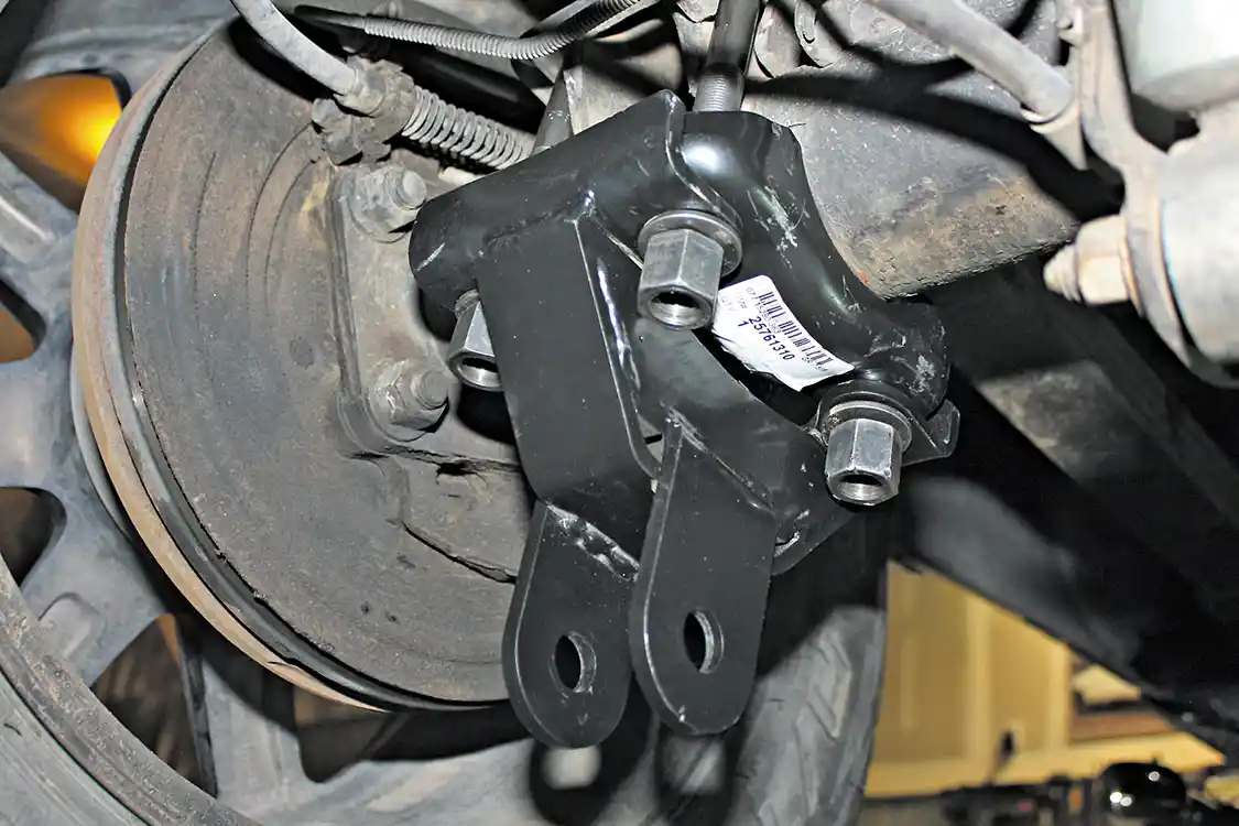 4. Notice the stock lower axle U-bolt clamp plate is retained; the professional grade traction bar bracket is just slid onto the axle U-bolts and the stock washers and nuts are reinstalled. The nuts will need to be torqued to 118ft-lbs. Try to tighten these evenly, so all four have the same length of stud showing when tightened. 