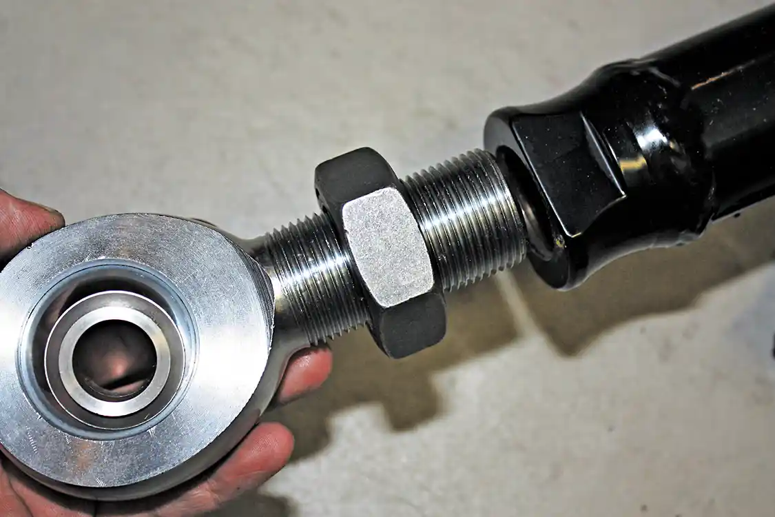 8. After determining which rod end needed to be threaded into each end of the bars, the jam nuts can be spun clear to the rod end, and then the rod end can be inserted into the bars, leaving about a quarter inch of threads sticking out. Remember to allow room for future length adjustment once its installed on the truck.