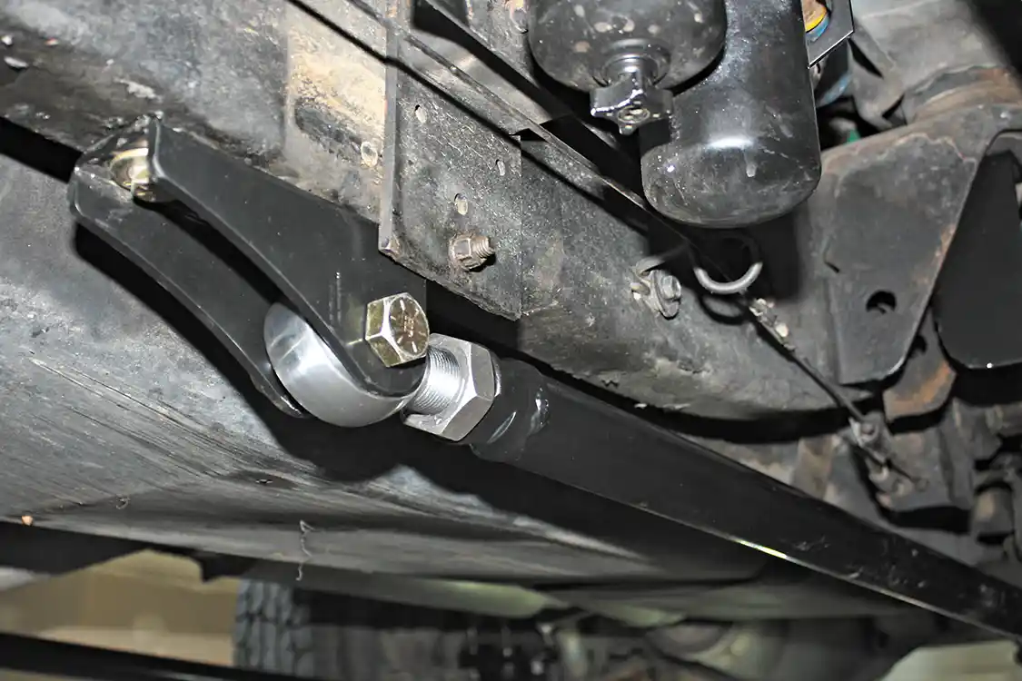 12. Bolting the bracket into place with the first hole allows you to use the other two holes already in the bracket as the template for drilling the last two holes in the frame. This ensures they are drilled in the precise spot of the frame so all three holes line up perfectly.