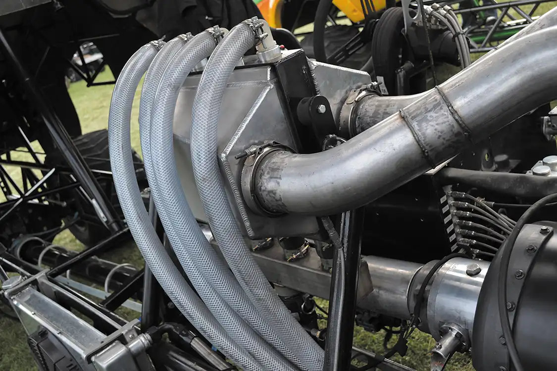 A heavily reinforced <a href="https://shop.precisionturbo.net/">Precision</a> air-to-water intercooler is used to control intake air temperatures down to slightly above ambient. The piping for the intercooler was built by Crank It Up Diesel, and the system consumes more than 80 lbs. of ice per pass.
