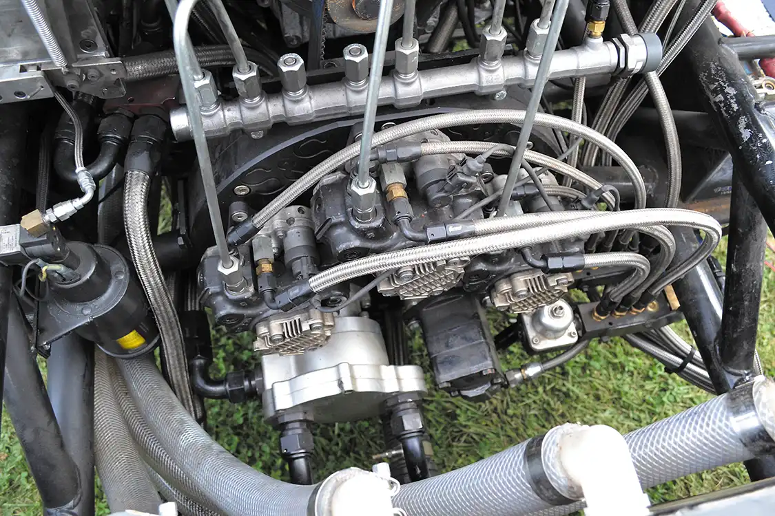 Perhaps the most interesting aspect of Kyle's build is the crazy fuel system, which employs three stock CP3 pumps to maintain 30,000 psi of rail pressure. Built by <a href="https://ssdiesel.com/">S&amp;S Motorsport</a>, the drive system has since ditched the water pump for the engine (far left) with a fourth CP3, as even with three pumps, Kyle's Duramax was still dropping rail pressure! A boost-referenced 700-gph Waterman lift pump provides 20-70 psi of pressure to the whole assembly.