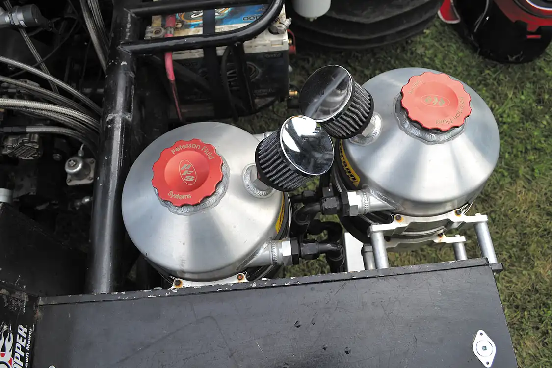 The oiling system for the Duramax system is quite complex, and uses an external wet sump system. Up front, four <a href="https://petersonfluidsys.com/tanks.html#">Peterson</a> tanks (two on each side) hold oil for both the engine and turbo systems, as well as diesel fuel, and water for the water injection system.