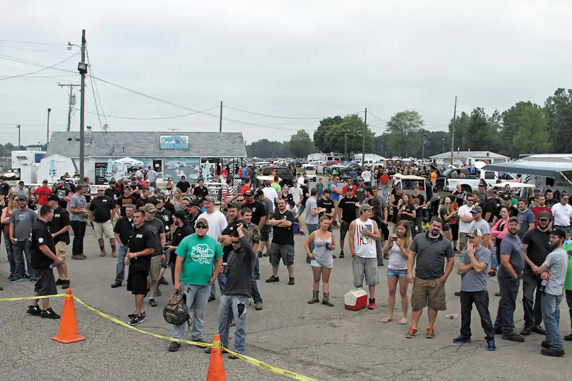 The crowd waiting for the next truck to be strapped down on the rollers…