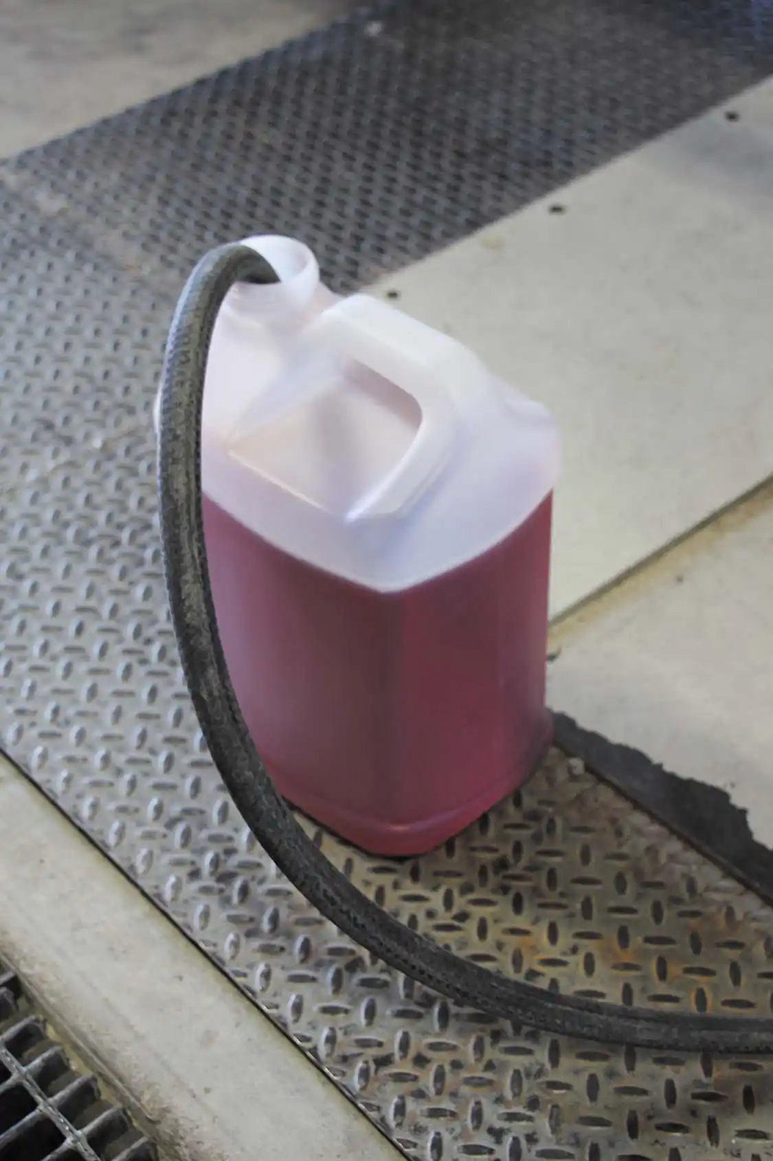 To test the Scheid fuel on the chassis dyno, we simply disconnected the 5/8-inch fuel line running from the truck’s tank to its lift pump and hooked an additional section of the same diameter hose onto it. This way, we knew we would be running pure Scheid fuel through the engine, not a diluted mixture. The fuel system continued to send its return fuel back to the tank (it enters through the top of the tank), and yes, the fuel disappeared quickly with nothing returning back to the test container. Still, we were able to make three solid, all-out dyno pulls with the 5 gallons of Scheid fuel on hand. Approximately half a gallon was left over after testing. The rest had made its way into the truck’s fuel tank via return.