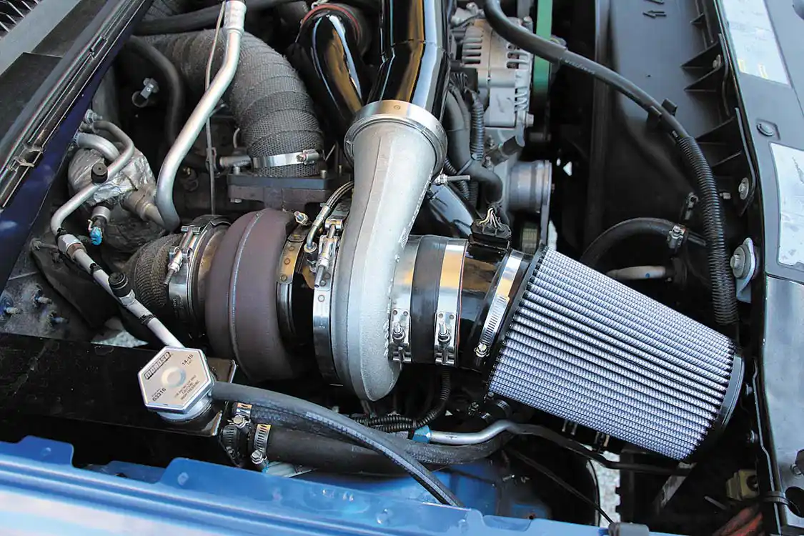 Kicking the passenger side battery out of its original location is this billet S480. It features the common 96mm turbine wheel, T6 flange, and 1.32 A/R turbine housing combination. In conjunction with the billet S366, the compound setup produces between 70-75 psi of boost on the street.