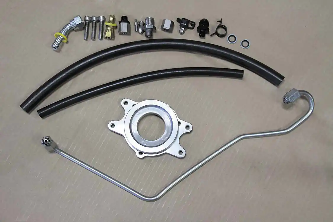 13. To bolt a CP3 in place of the factory CP4.2, a CP3 conversion kit had to be employed. This system from Wehrli Custom Fabrication comes with everything needed to perform the swap, including a pump flange plate, new high-pressure fuel line, fittings, and all necessary hardware. Once the CP4.2 is removed, the supplied flange can be installed on the CP3, followed by the factory drive gear.