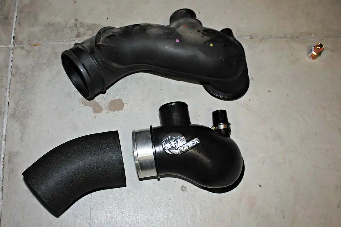 6. Comparing the stock turbo inlet manifold (top) to the new aFe Bladerunner, you can see the improvement from making smoother radiuses and bends, eliminating restrictions in the airflow passage before the turbocharger. The aFe piece is a direct replacement with no modifications required.