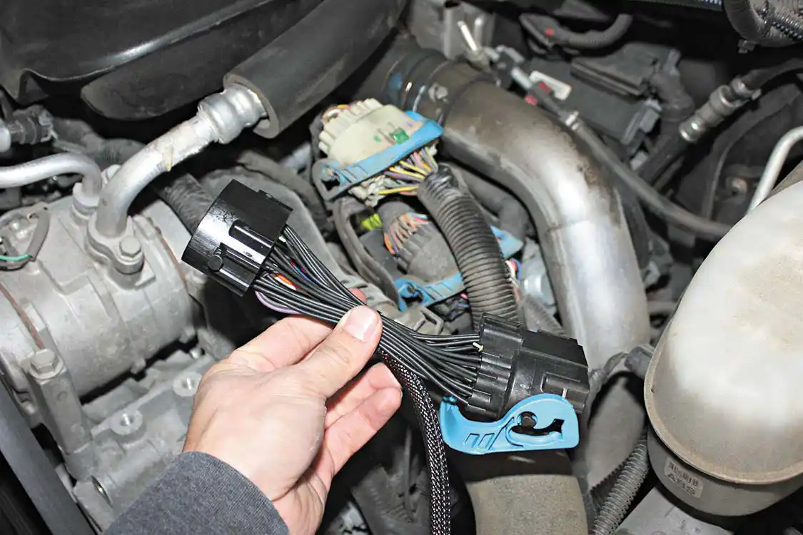 11. Under the hood, the Edge Juice with Attitude system will piggyback into a few factory harnesses, including the main engine control harness. Simply unplugging the factory connector and placing the new harness in between the two OEM plugs will give the Juice module all the engine data and parameters it needs access to make fine adjustments to improve drivability, power, and towing performance.