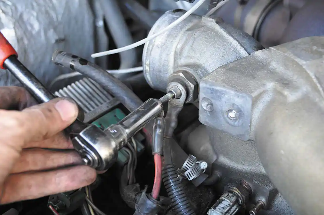 12. Here the intake air heater is being unbolted. The air temperature sensor and a couple boost lines were also removed from the intake spyder.