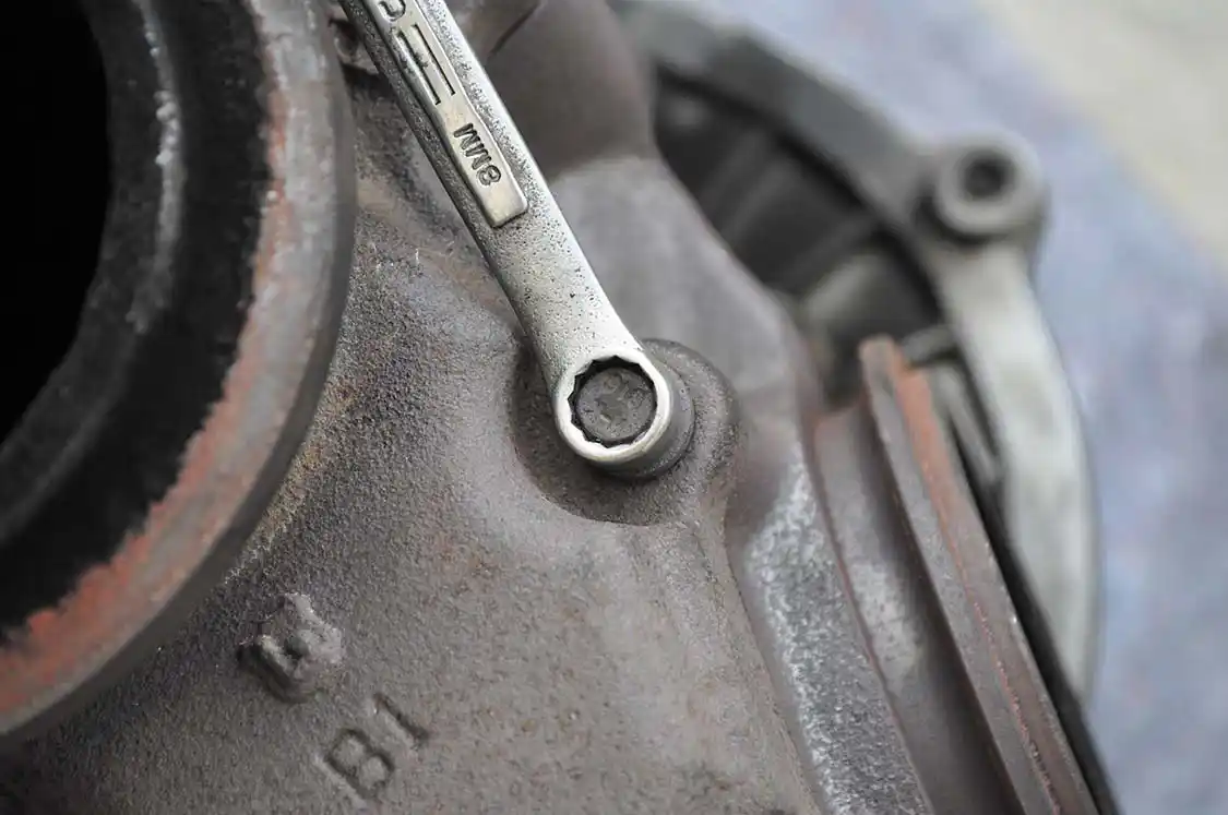 22. We used an 8mm, 12-point box end wrench to remove the bolts holding the flange to the turbine housing.