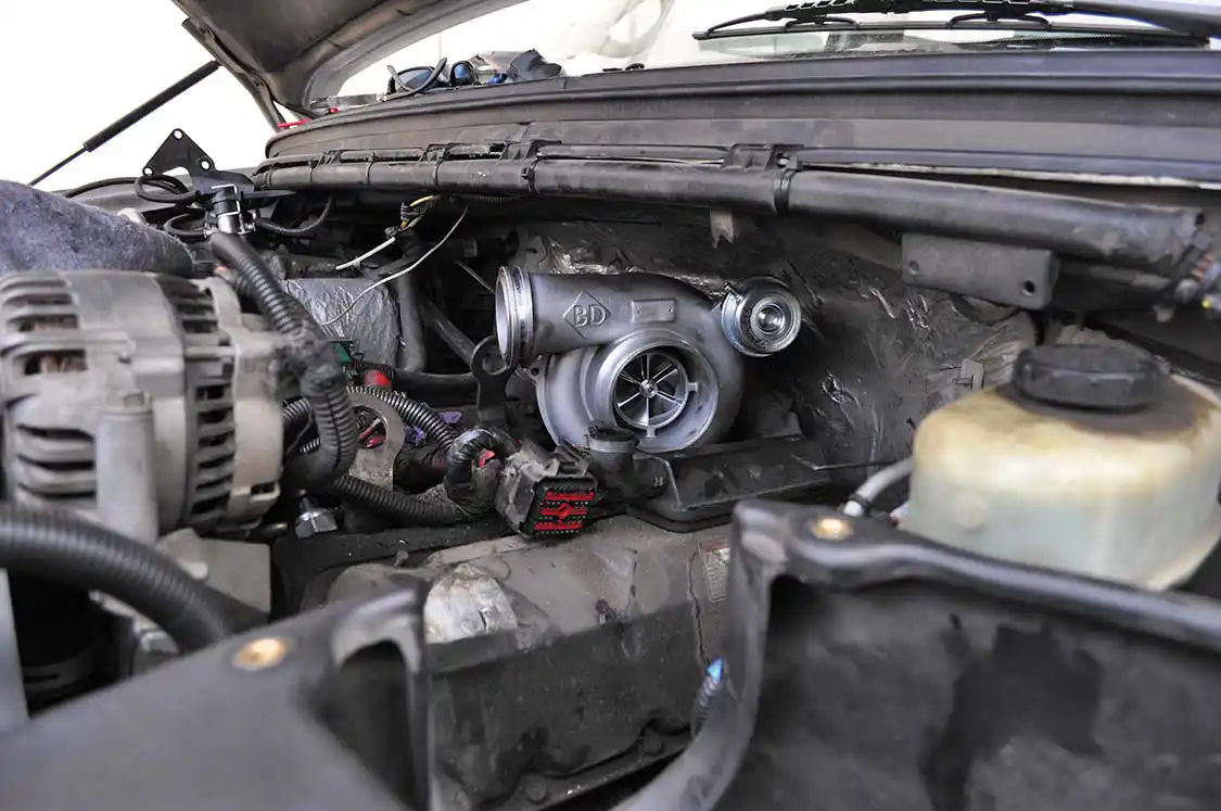 25. Installation was simply the reverse of the removal process. The only difference is the use of BD’s turbo inlet tube instead of the stock part. The intake on the turbo is way too large for the stock inlet tube. The new BD inlet tube bolted up in the stock location with ease.