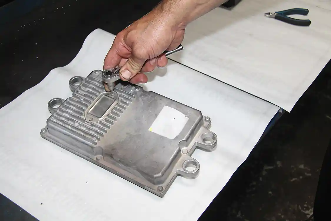 4. The cover plate is removed from the top of the FICM. Normally, the cover is removed for under-hood testing; we recommend replacing it before removing the FICM in order to prevent damage.