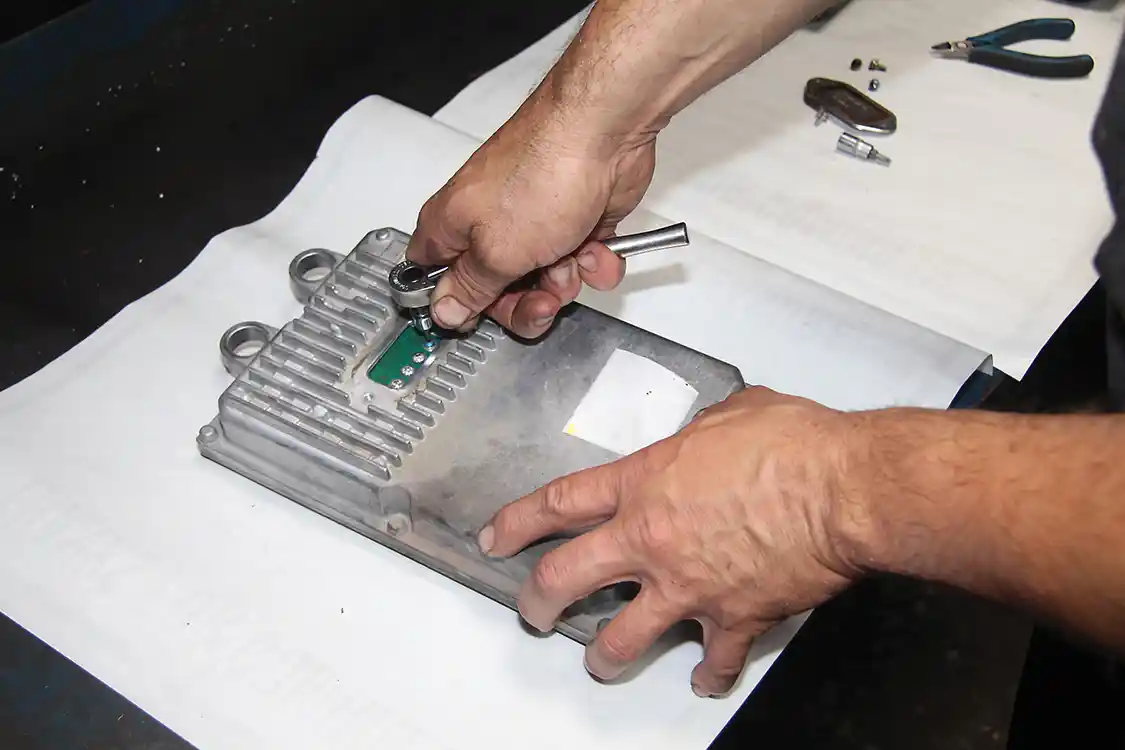 5. With the cover window removed, you will see either four or seven pins. This tells you which type of FICM you have. These screws must be removed to disassemble the FICM.