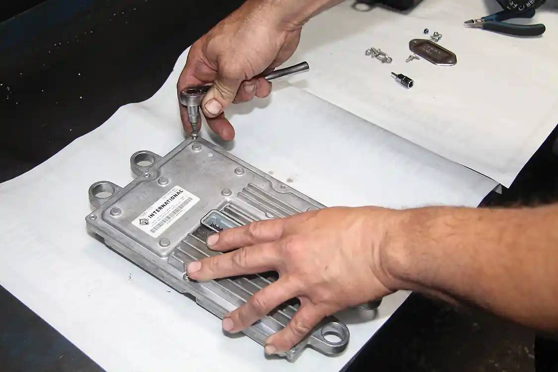 6. With the screws under the window cover removed, flip the FICIM over, remove the eight screws that hold the case together, and carefully pry the two halves apart.