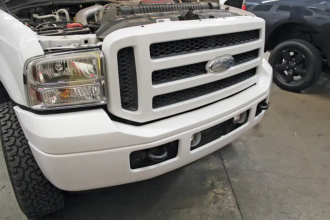 19A/19B. As you can see from these before and after shots, the finished product completely transforms the look of the truck. The Royalty Core grille and TrailReady bumper make a great pair and give the nose of the truck a strong, aggressive look. And the modifications are functional—the heavy-duty bumper won’t succumb to parking lot dings, and the grille turns night into day. Not bad for about four hours of work!
