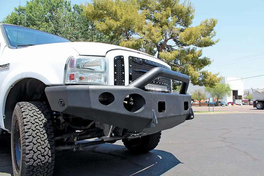 19A/19B. As you can see from these before and after shots, the finished product completely transforms the look of the truck. The Royalty Core grille and TrailReady bumper make a great pair and give the nose of the truck a strong, aggressive look. And the modifications are functional—the heavy-duty bumper won’t succumb to parking lot dings, and the grille turns night into day. Not bad for about four hours of work!