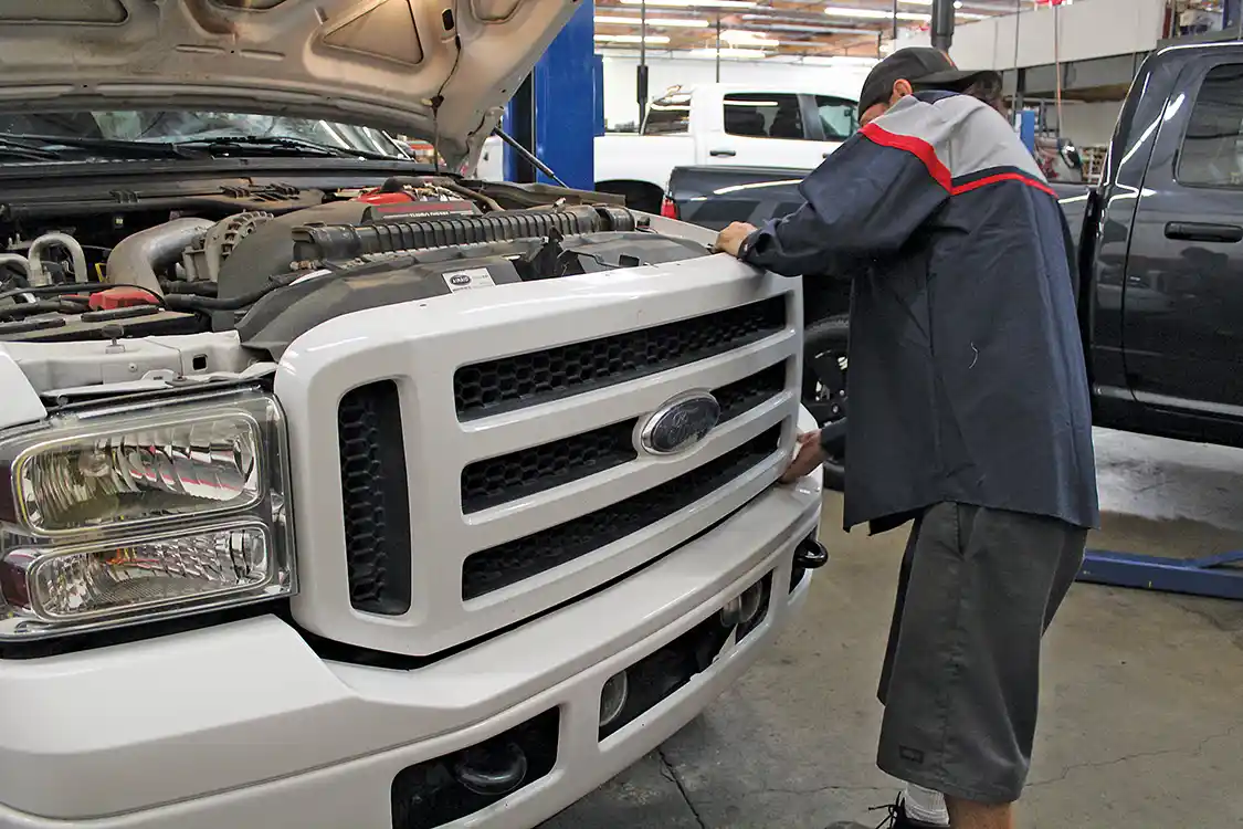 2. Just like last month’s bumper installation, Brett Corder of 4Wheel Parts Wholesaler is fitting the grille to our F-250. He starts by unbolting the stock grille, which is held in place with four small bolts along the top and retaining clips along the bottom. The grille must be removed with care, as the shell will be re-used.
