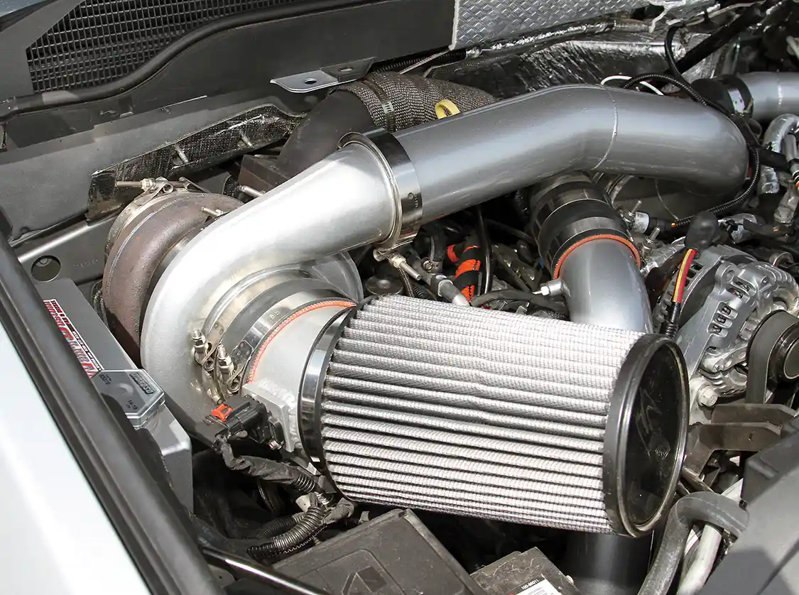 The team at <a href="https://www.wcfab.com/">Wehrli Custom Fabrication</a> removed the passenger side battery and factory coolant overflow tank to make room for an additional turbocharger. Compounded with the factory VVT turbo, this setup makes more power while maintaining drivability.