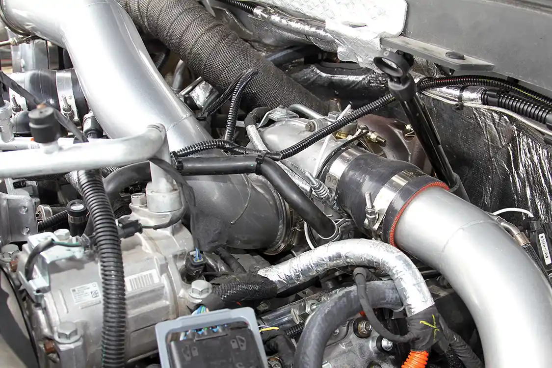 Jason Wehrli and his team fabricated new boost tubes to feed the intake charge from the new <a href="https://www.borgwarner.com/home">BorgWarner</a> S475 turbo into the factory VVT unit, as well as high-flow tubing from the outlet of the factory compressor to the intercooler and from the intercooler to the intake.