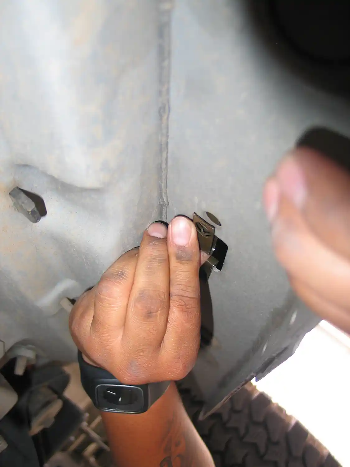 1. Installation starts by slipping eight mounting clips (four on each side) onto the factory running board locations on the frame rails. A small bolt is put in place and finger-tightened.