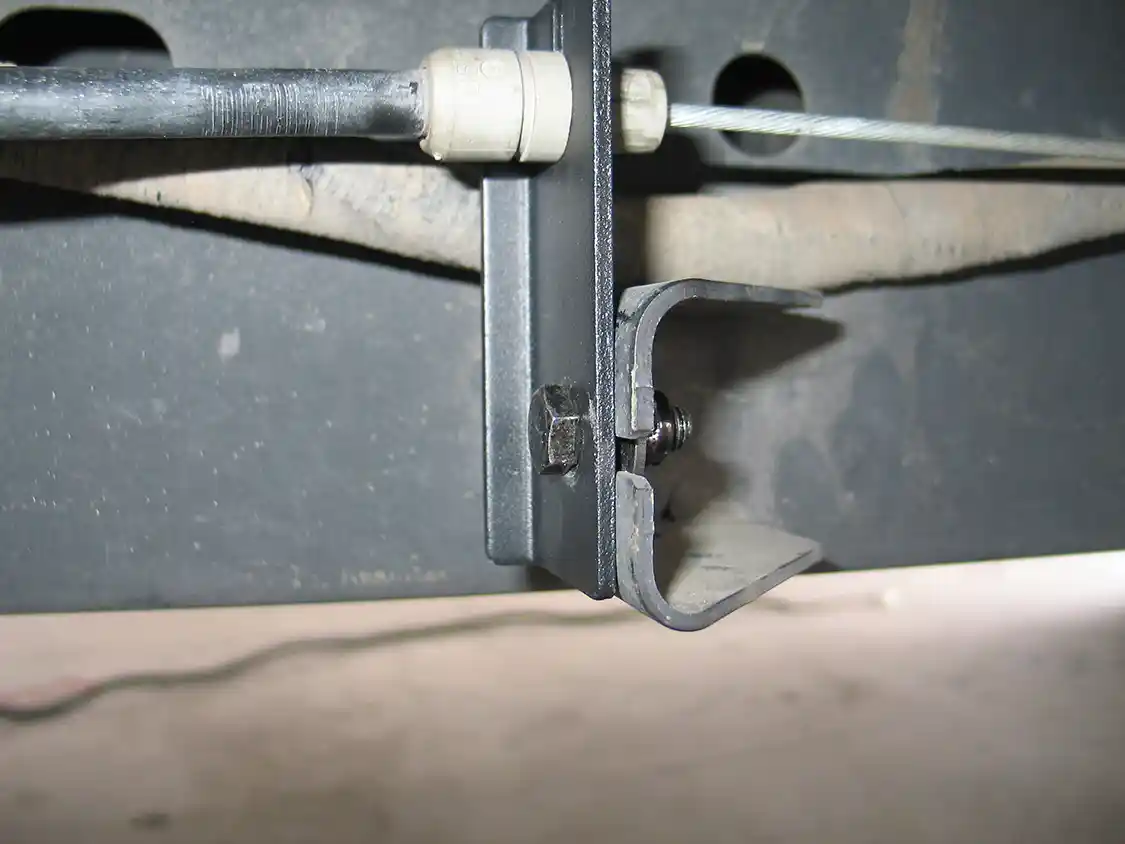 5. The supplied brake cable bracket extension mounts to the driver’s side frame rail, with the brake cable removed from the factory bracket and attached to the extension. This keeps the brake cable out of the step’s path when it retracts.