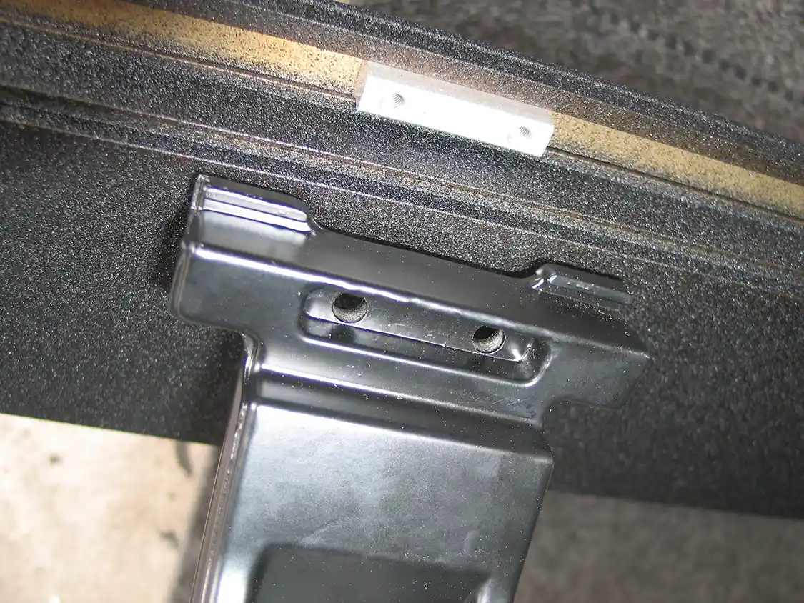 6. The step is mounted to the linkage. The aluminum T-nut slides back and forth in a groove on the step, so it can be aligned with the linkage arms.