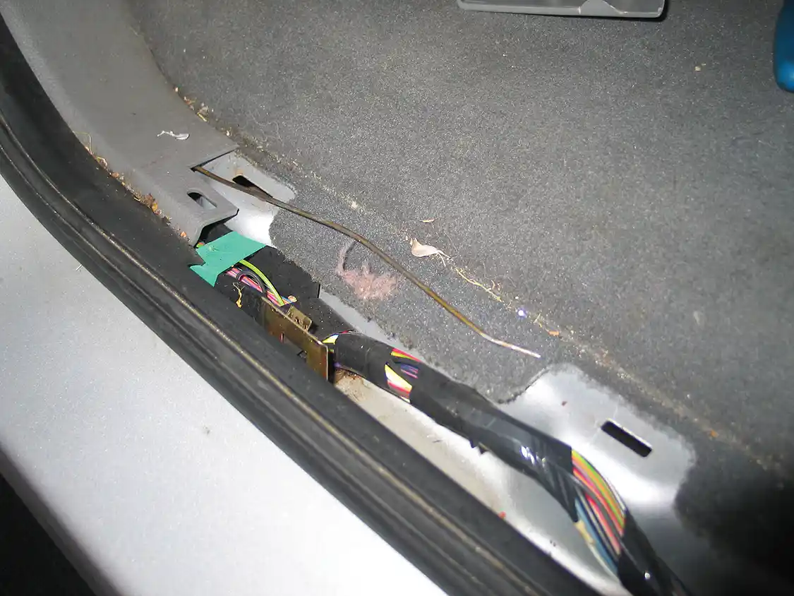 13. Removing the step plates from the front and rear door openings provides access to the wiring harness. Use a coat hanger to pull the trigger wires underneath the B-pillar covers to the rear passenger area.