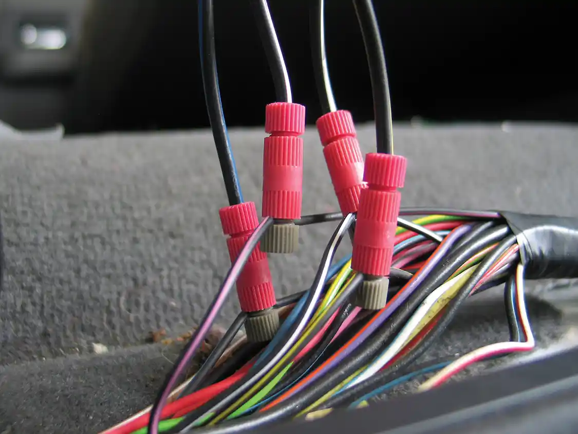 14. There are four trigger wires from the PowerBoards kit that must be spliced into the truck’s existing wiring harness to alert the controller that a door has been opened. Each wire’s color corresponds with similarly colored wire from the truck, and they can be attached using the supplied <a href="https://www.posi-products.com/index.html">Posi-Taps</a> connectors. Note that there are three blue wires in the truck’s harness. Use the one that doesn’t look like the other two.