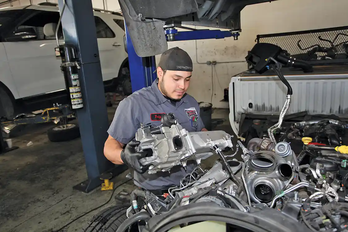 5. After the plastic is off, Henriquez removes the aluminum manifold.