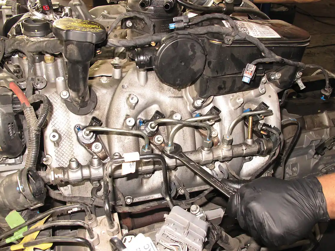 6. The entire fuel system is stripped out. Here the injector feed lines are being removed.