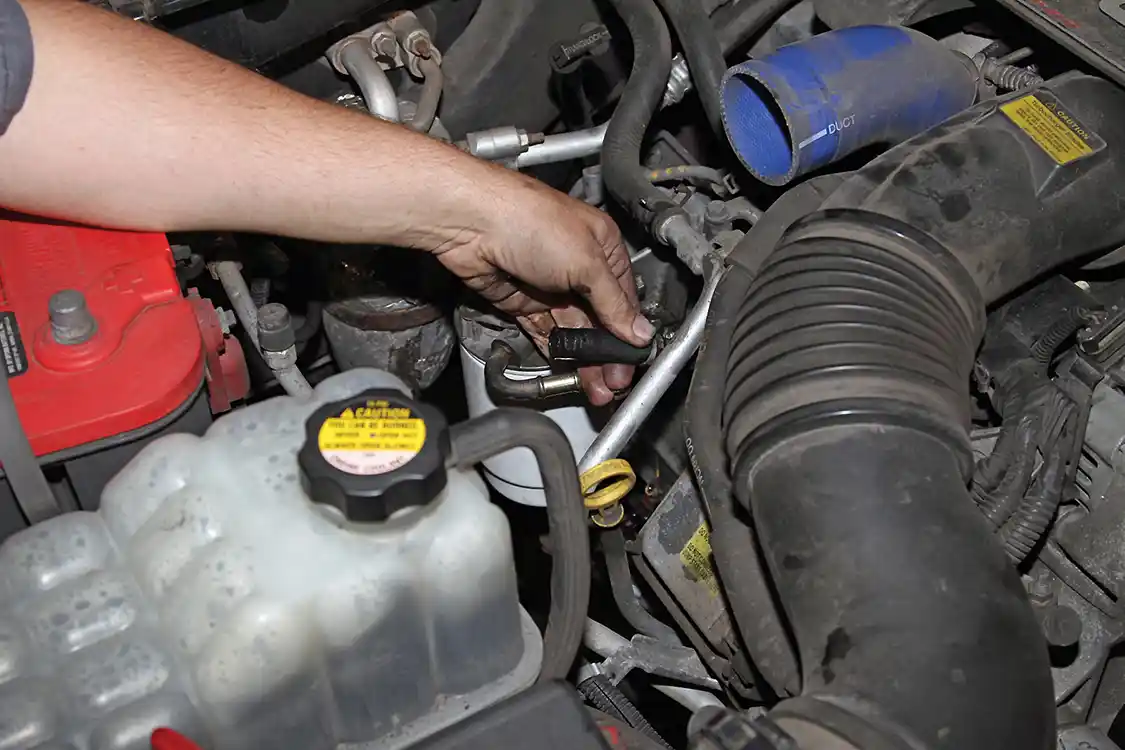 4. With clear access to the fuel filter assembly, Phaff loosened the spring clamps on the fuel lines and slid the lines off the fittings.