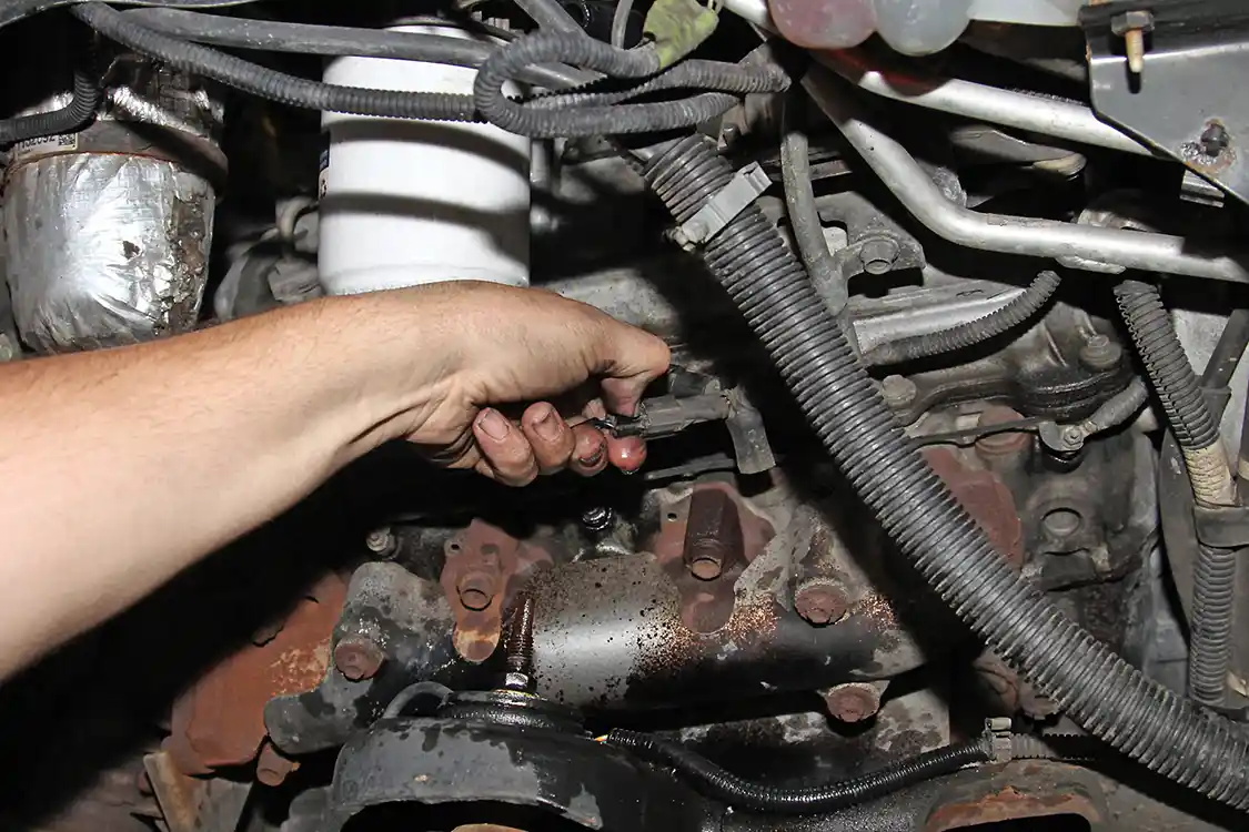 6. Both the water-in-fuel sensor harness and the fuel heater harness must be unplugged before the filter assembly can be removed from the engine.