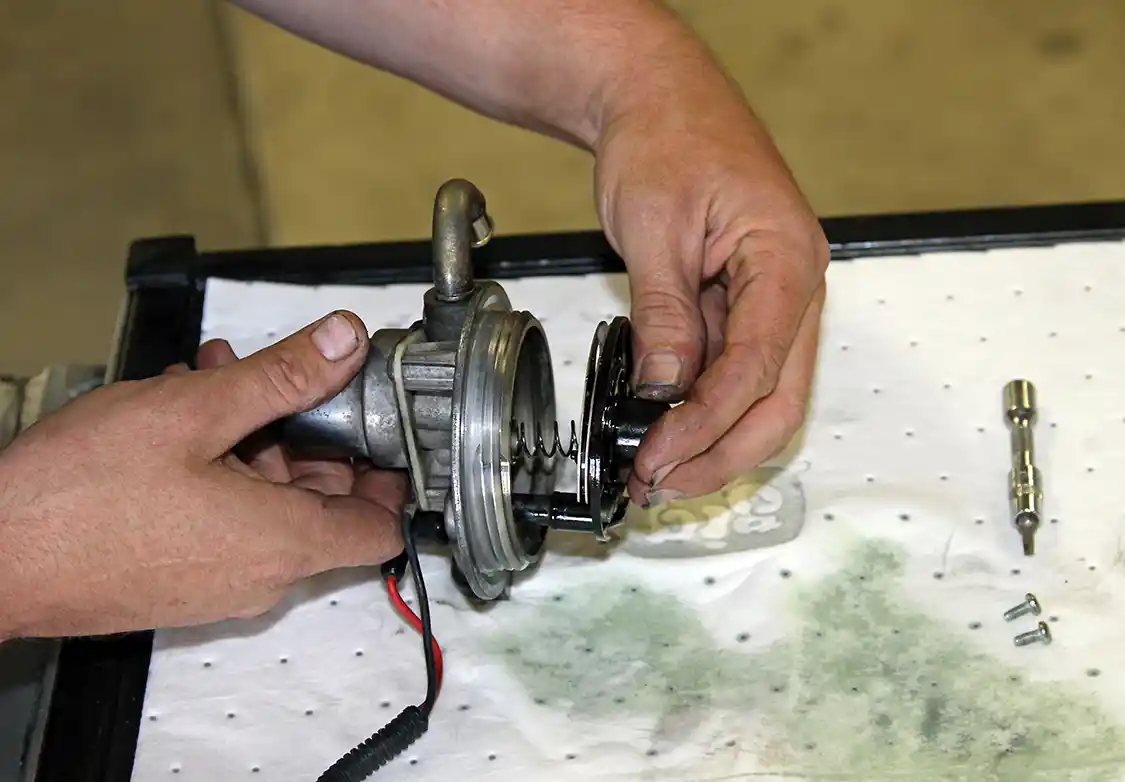 12. He then disconnected the heater power lead and pushed the heater assembly out of the filter head, making sure not to loose the spring or check ball in the process.
