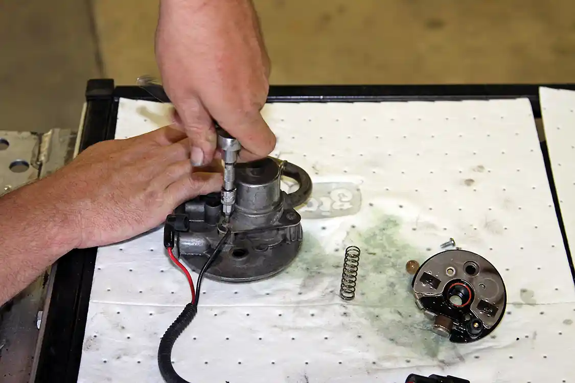 13. Next, Phaff removed the Torx screws securing the plunger to the filter head, noting the position of the fuel heater ground lead.
