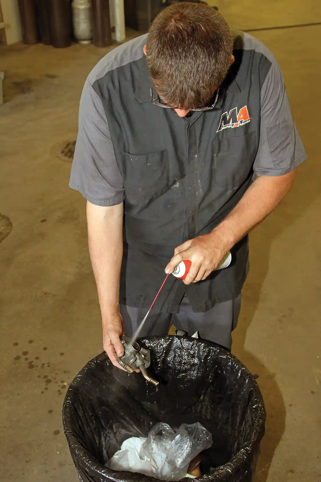 16. After the filter head is completely disassembled, Phaff cleans it with a steady stream of brake cleaner to dislodge any dirt or debris that may have accumulated over the years in order to make sure it does not get inside the fuel system during reassembly.