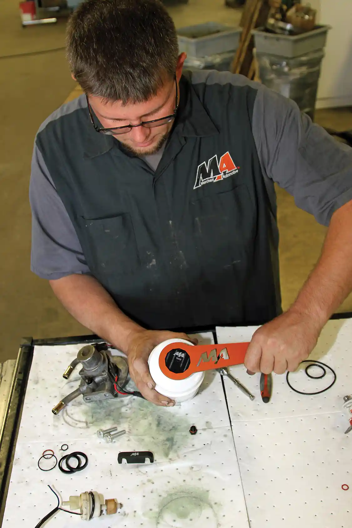 22. After verifying that the seals are working well within the rebuilt filter head, Phaff installs the billet aluminum WIF plug using an MA WIF wrench. It can also be installed with a 3/8-inch square-drive ratchet using a machined recess in the plug. He then installed the filter on the filter head. When doing this job, be sure to install the O-ring for the filter, otherwise you’ll end up with a big mess on your garage floor.
