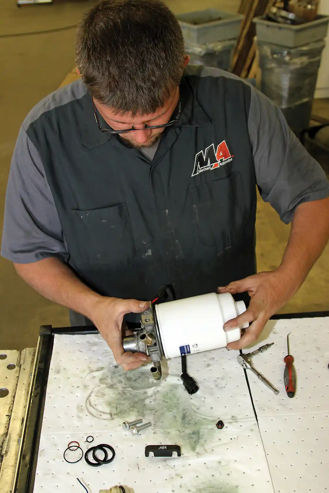 23. After verifying that the seals are working well within the rebuilt filter head, Phaff installs the billet aluminum WIF plug using an MA WIF wrench. It can also be installed with a 3/8-inch square-drive ratchet using a machined recess in the plug. He then installed the filter on the filter head. When doing this job, be sure to install the O-ring for the filter, otherwise you’ll end up with a big mess on your garage floor.