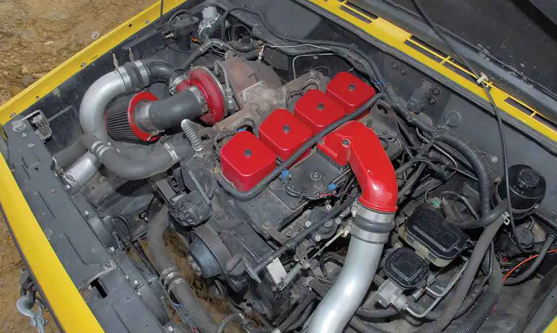 The original air horn was too close to the hood and pointed in the wrong direction. To cure this, Bankston removed the intake heating grid and milled down the four-bolt flange, then bolted up a 6BT air horn, which points in the right direction. The intercooler is half of a 6.0L Power Stroke unit with the end tanks from a Ford F-700 soldered on. These tanks used 3-inch connections and Don used 3-inch mandrel tubes from a Dodge van exhaust to plumb it all up.